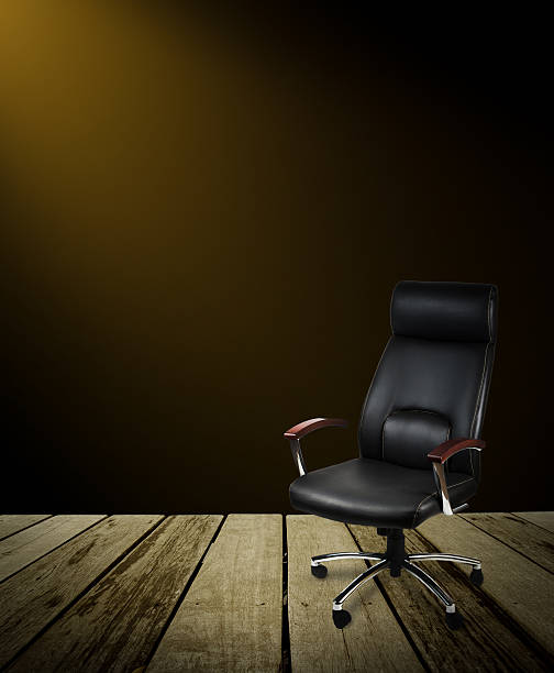 istock Black leather office chair on wood floor,dark background 514473538