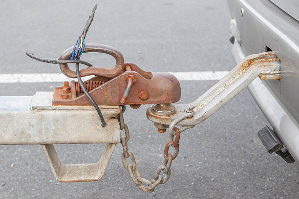 Closeup the grungy tow car with connected hook and chain.