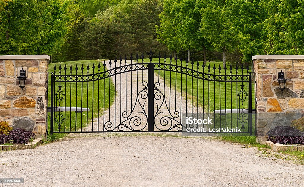 Double wrought-iron gate Wide wrought-iron gate between two columns Gate Stock Photo
