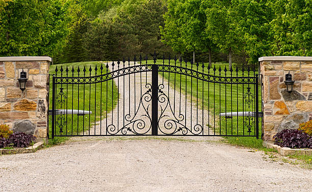 Double wrought-iron gate Wide wrought-iron gate between two columns gate stock pictures, royalty-free photos & images