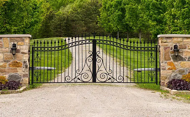 Wide wrought-iron gate between two columns