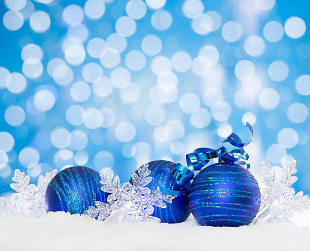 istock Christmas snow with blue baubles and snowflake lights 514475669