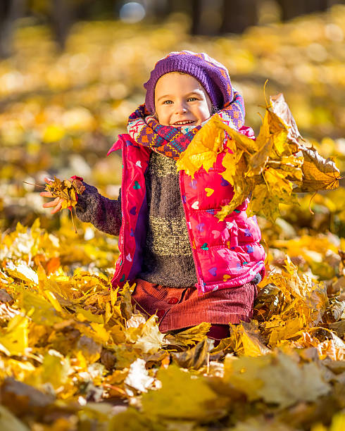 istock Little girl playing with autumn leaves 514476793