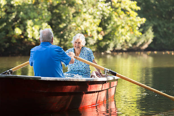 istock Happy senior couple rowing a boat on lake 514476861