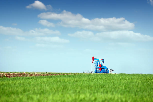 istock oil pump jack on green field 514478087