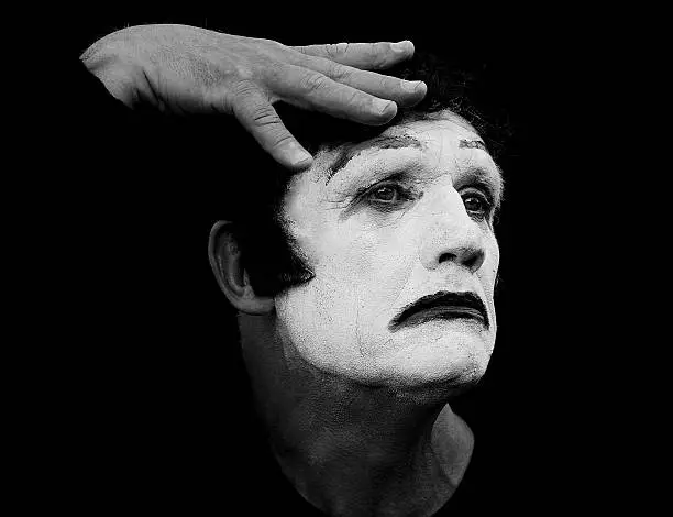 black and white shot of a mime artist looking sad