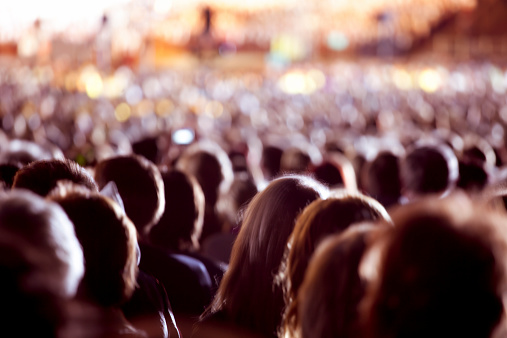 Large crowd of people watching concert or sport event