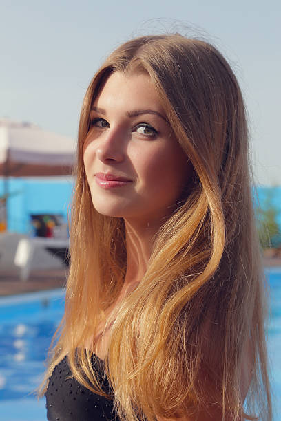 istock Young pretty girl in bikini in outdoors pool. 514483319