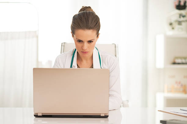 istock doctor woman working on laptop in office 514497910
