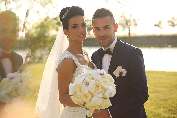 istock Bridal couple with bouquet posing on wedding day 514498510