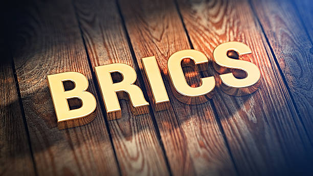 Acronym BRICS on wood planks The acronym "BRICS" is lined with gold letters on wooden planks. 3D illustration picture brics stock pictures, royalty-free photos & images