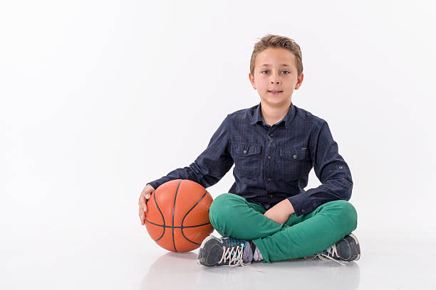 istock Boy with a basketball ball isolated 514499394