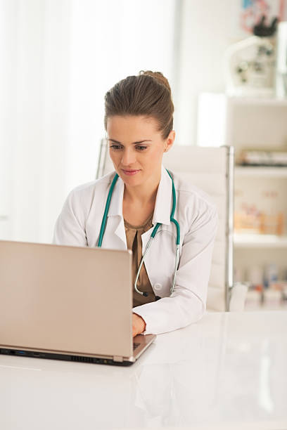 istock doctor woman working on laptop 514499534