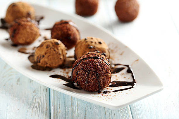 istock Sweet chocolate truffle on a blue wooden table 514499590