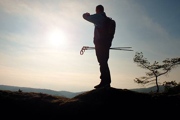istock Alone man backpacker at sunrise at open view on mountain 514500022