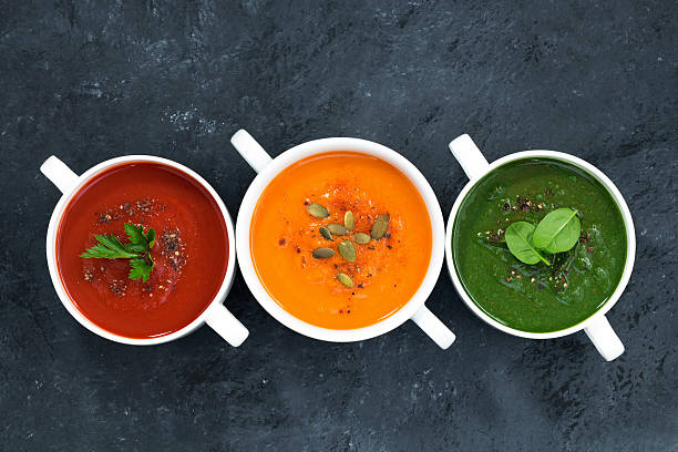 assortment of fresh vegetable soup on a dark background