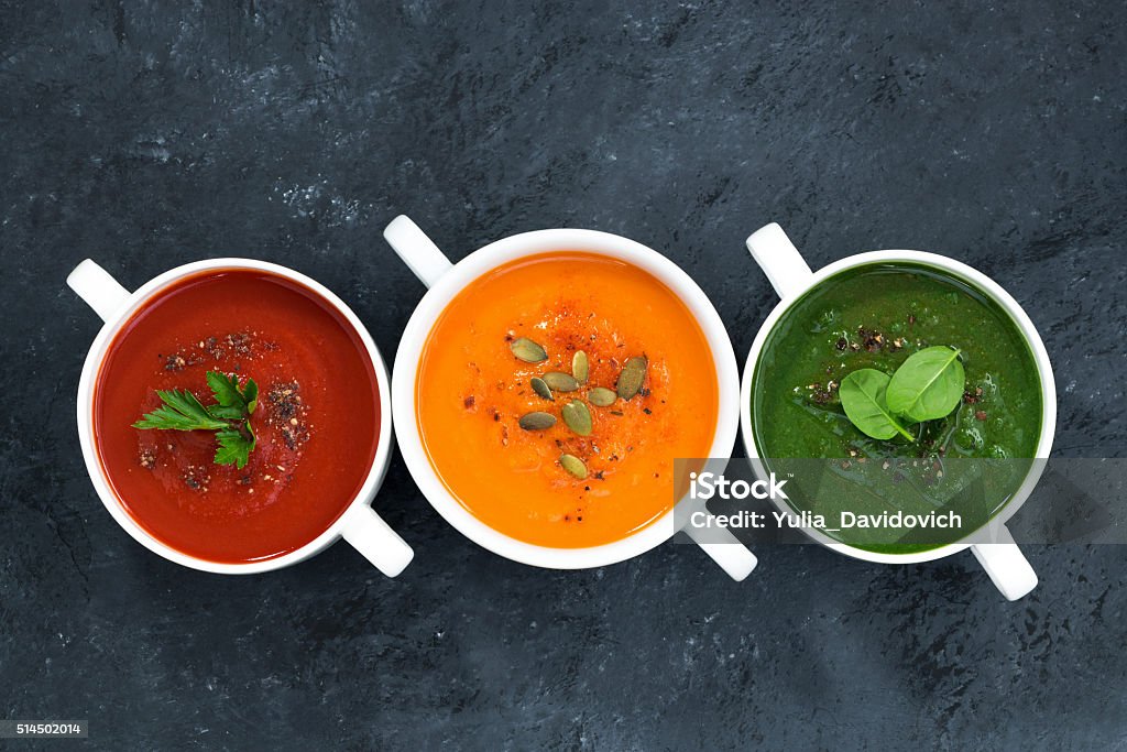 assortment of fresh vegetable soup on a dark background assortment of fresh vegetable soup on a dark background, top view Soup Stock Photo