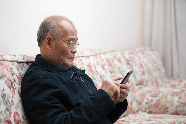 istock Asian old man use smart phone indoors 514504474