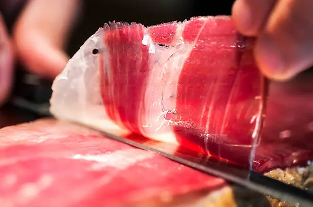Photo of Detail of knife cutting jamon iberico