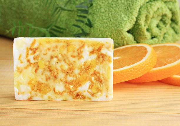 Bar of handmade citrus soap with orange zest.