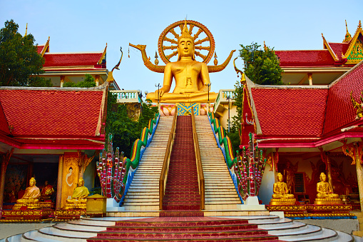 Religion In Thailand. Golden Statue Of Buddha With Dragon Staircase In Wat Phra Yai, The Big Buddha Temple At Koh Samui. Place For Praying, Meditation. Buddhism. Religious Symbol. Travel, Tourism.