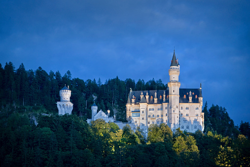 Hohenschwangau, Germany - August 15, 2014: Neuschwanstein Castle illuminated by night, a famous palace commissioned by Ludwig II of Bavaria