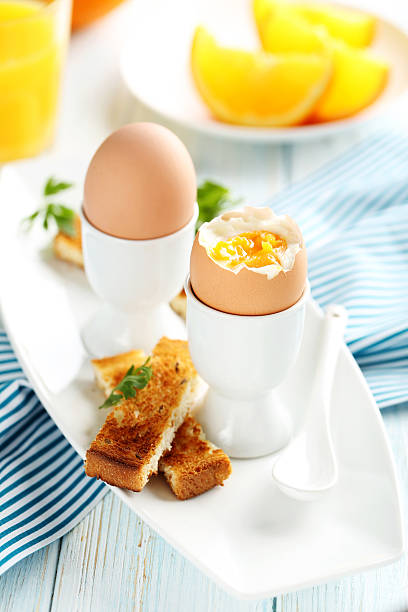 istock Boiled egg with toasts on a blue wooden table 514513248