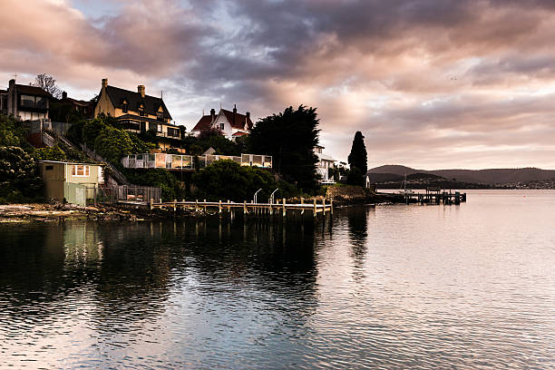 istock Cloudy Sunrise Over Derwent Estuary Reflecting Warm Tones and Homes 514513334