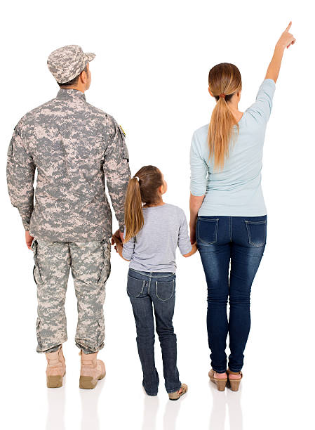 vista posteriore di famiglia militare che indica uno spazio vuoto - rear view family isolated child foto e immagini stock