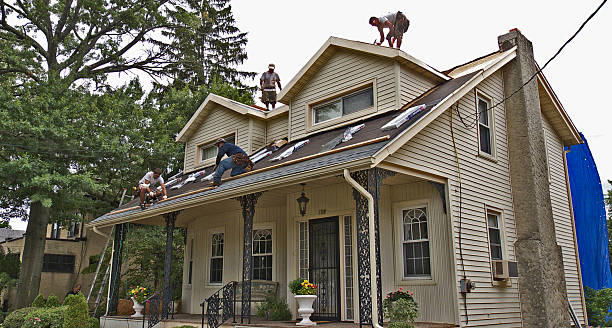 Home roofing. Audubon, New Jersey, USA - September 8, 2014: Overall view of a roofing contractor and his men working on a residential home. wood shingle photos stock pictures, royalty-free photos & images