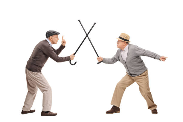 istock Two senior man in a sword fight with canes 514513668