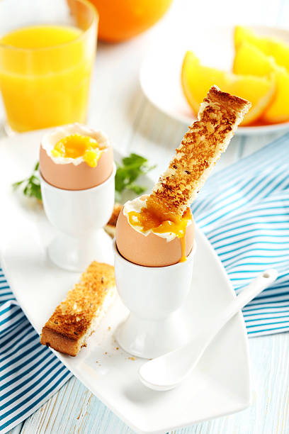 istock Boiled egg with toasts on a blue wooden table 514513712