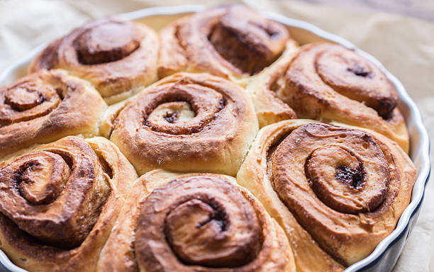 istock Cinnamon rolls on the wooden background 514513762