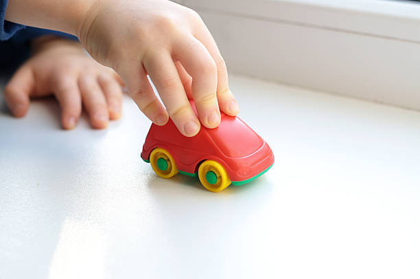 istock Little child hand close up playing toy 514515162