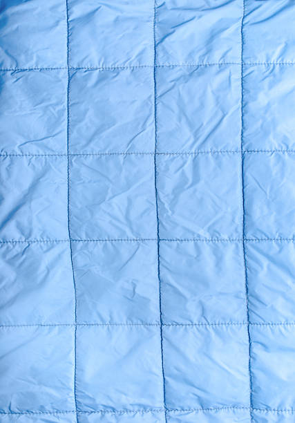 istock Closeup of blue silk quilted fabric as a background 514515653