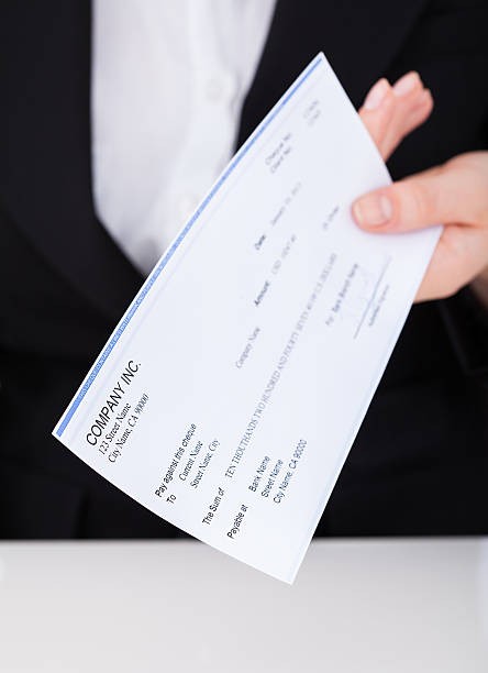 istock Smiling Businesswoman Holding Cheque 514516621