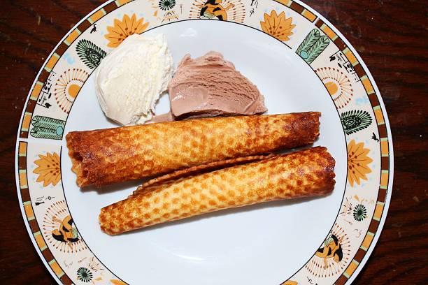 Homemade waffle tubes A close-up photo of Homemade waffle tubes on the plate ice cream with wafer rolls stock pictures, royalty-free photos & images