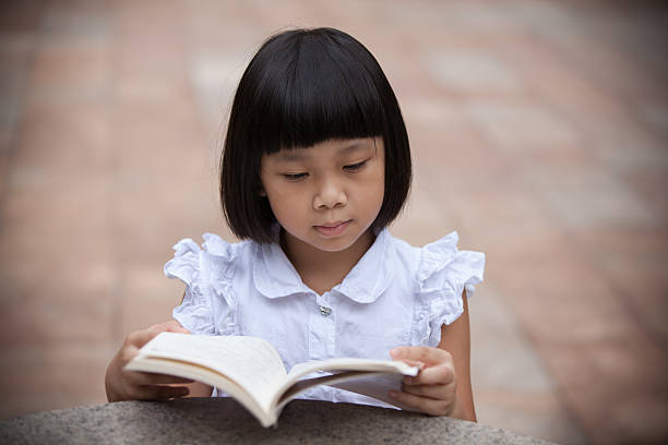 istock Asian girl read outdoors 514517870