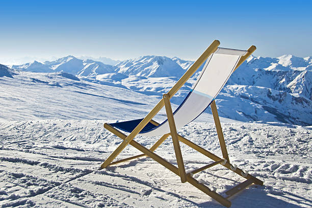 istock Deckchair in the snow facing the Alps mountains 514518403