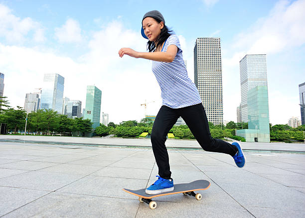 istock skateboarding woman jumping 514518531