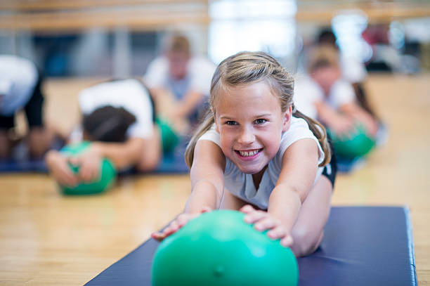 Kids Bender ball Group of kids doing fitness indoors physical education stock pictures, royalty-free photos & images