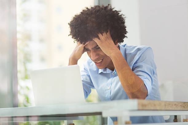 istock Tired afro man with laptop 514518648