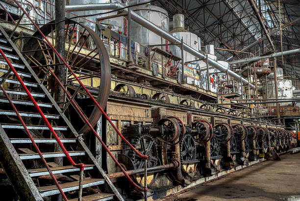istock Central shaft driving by belt other machines in old  factory 514518708