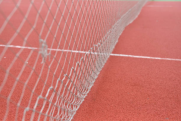 istock net tennis on field made from red granule rubber 514519410