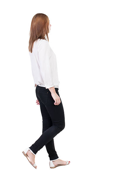 istock back view of walking  woman in jeans. 514531447