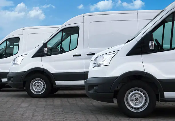 Photo of White delivery vans in a row