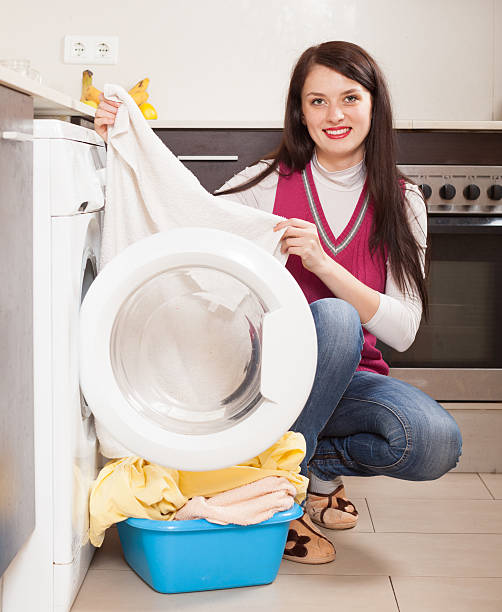 istock girl doing laundry with washing machine 514532817