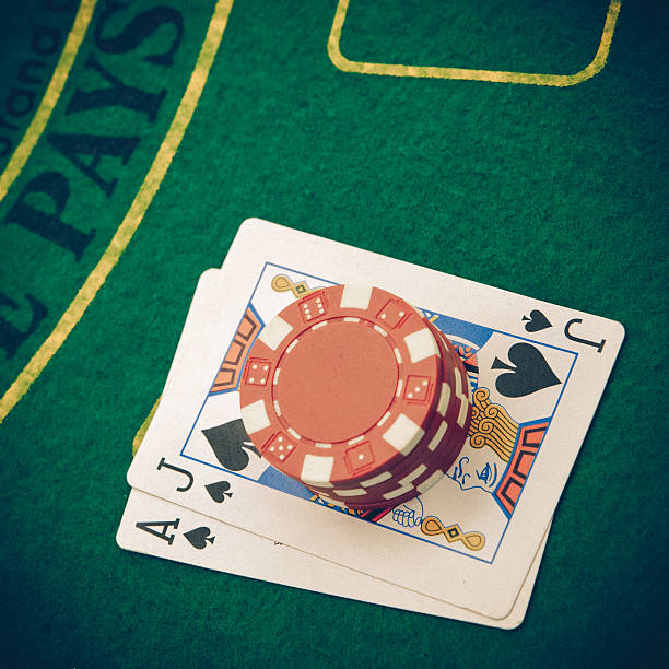 istock Ace of hearts and black jack with red poker chips 514535647