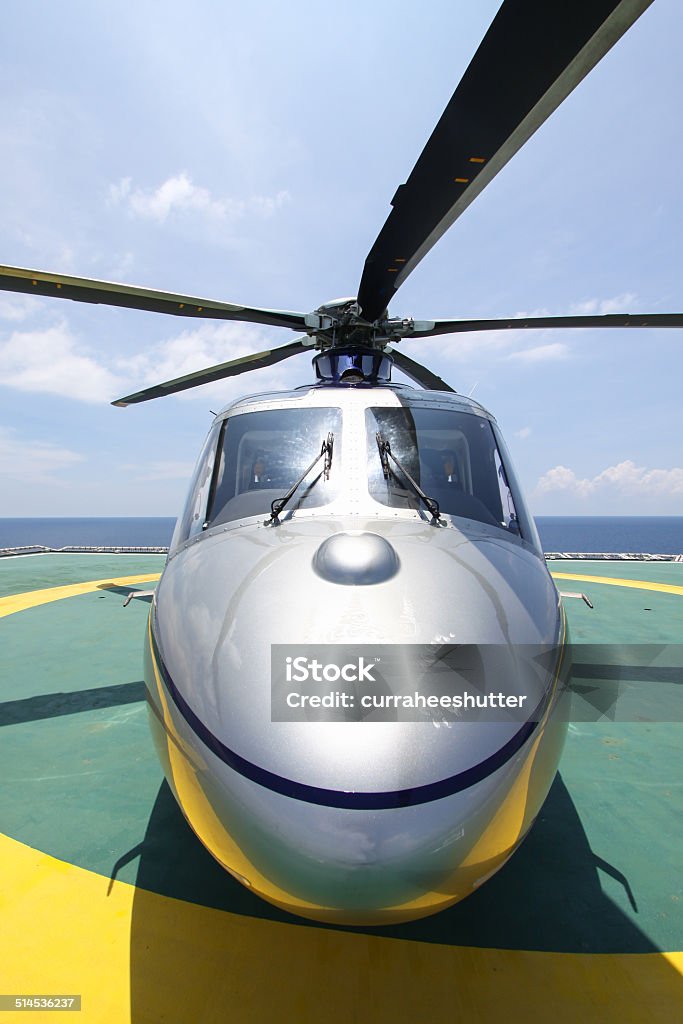 helicopter parking landing on offshore platform. helicopter parking landing on offshore platform. Helicopter transfer crews or passenger to work in offshore oil and gas industry. Aerial View Stock Photo