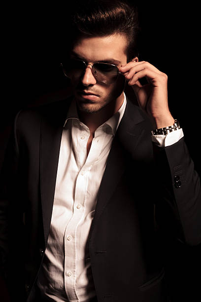 istock cool elegant man holds his sunglasses 514536309
